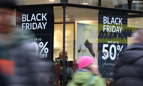 Shops in Canterbury, Kent, display offer posters ahead of Black Friday sales.