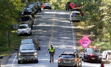 Police and cars in a road in the woods in Gansevoort, New York.