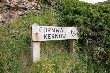 A sign marking the Cornish side of the wooden bridge at Marsland Mouth.