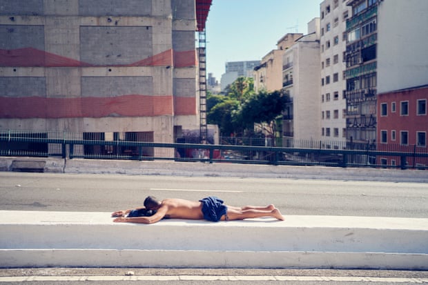 A man sunbathes on the Minhocão Viaduct