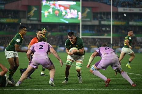 Elrigh Louw of South Africa scores their team's third try as they're tackled by Scott Cummings and Ewan Ashman of Scotland.