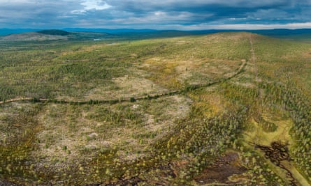 Aerial shot of a hillside of largely cleared woodland