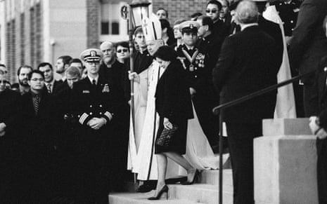 Gayle Benson walks to receive the casket of her husband, Tom Benson, with Archbishop Gregory Aymond in New Orleans in 2018.