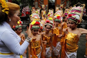 Girls listen to their instructor before performing the Rejang Dewa dance in the run-up to the Hindu holy day of Nyepi in Jakarta, Indonesia