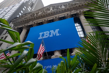 A large blue IBM banner hangs on the New York Stock Exchange facade, framed by palm fronds