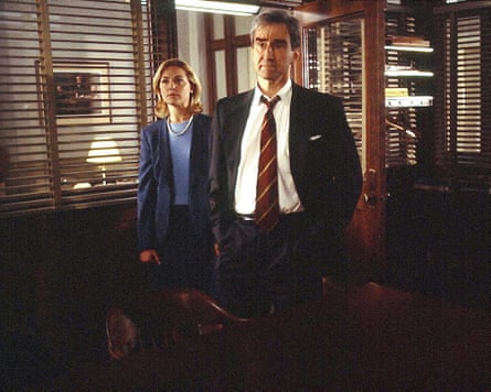 Woman and man stand in office