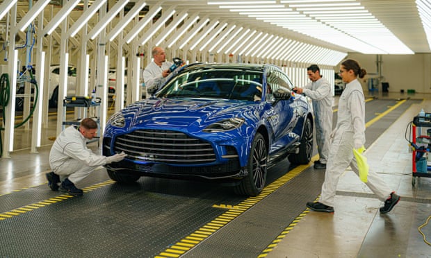 Paint technicians inspect the first production Aston Martin DBX 707 as it prepares to leave the  St Athan factory in Barry, Wales.