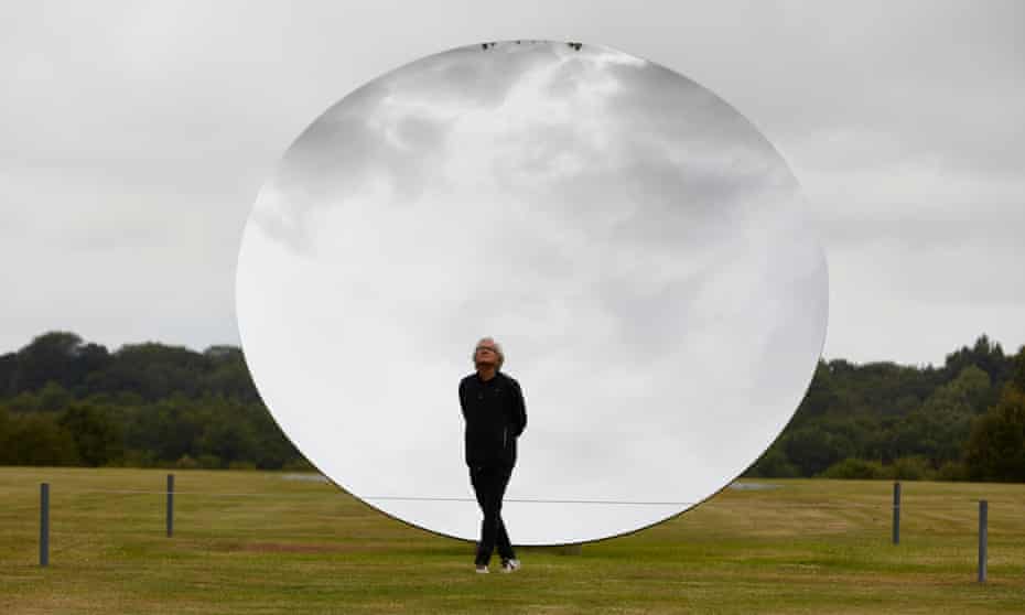 Anish Kapoor before his Sky Mirror sculpture at Houghton Hall, Norfolk, where he has a new exhibition.