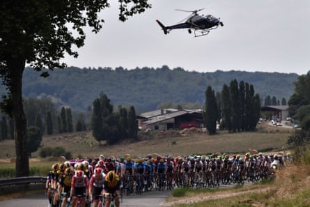 A television helicopter follows the peloton in 2019.