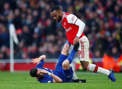 Arsenal’s Alexandre Lacazette clashes with Chelsea’s Jorginho.