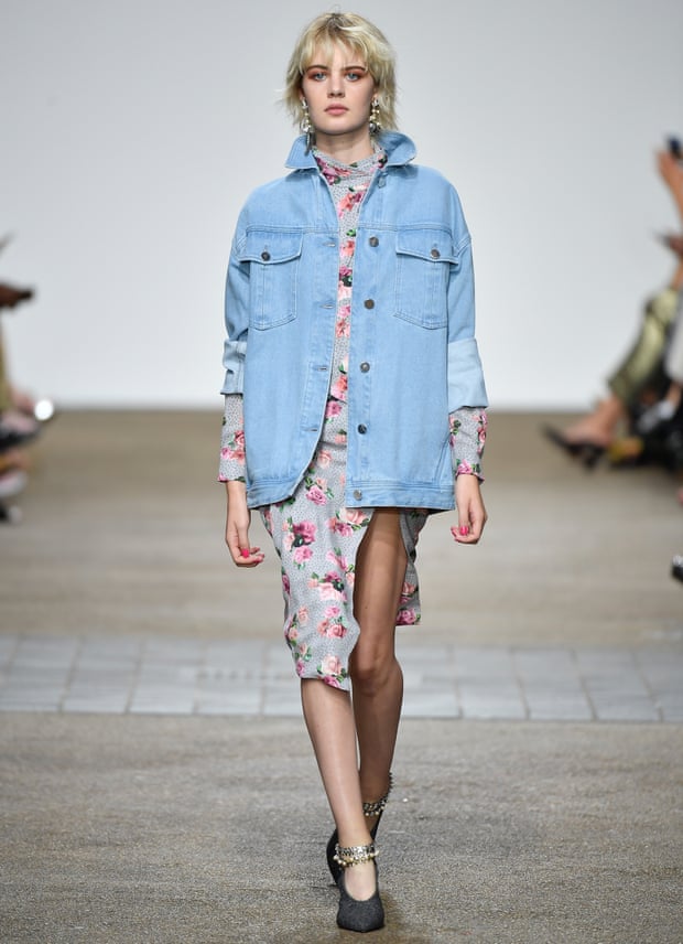 An oversized denim jacket over a floral dress, as seen at the Topshop Unique show.