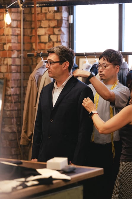 Andy Burnham gets fitted for a garment at Private White VC’s Manchester shop