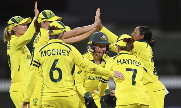 Australian players celebrate the wicket of England's Amy Jones.