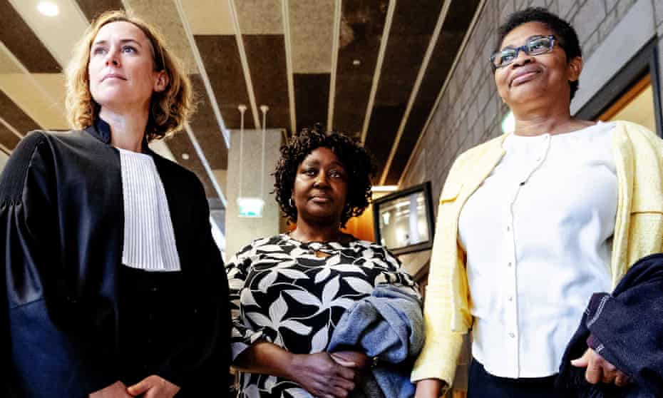 Esther Kiobel, right, and Victoria Bera, centre, whose husbands were among nine men killed in Nigeria in 1995, stand alongside their lawyer Channa Samkalden after the hearing in The Hague