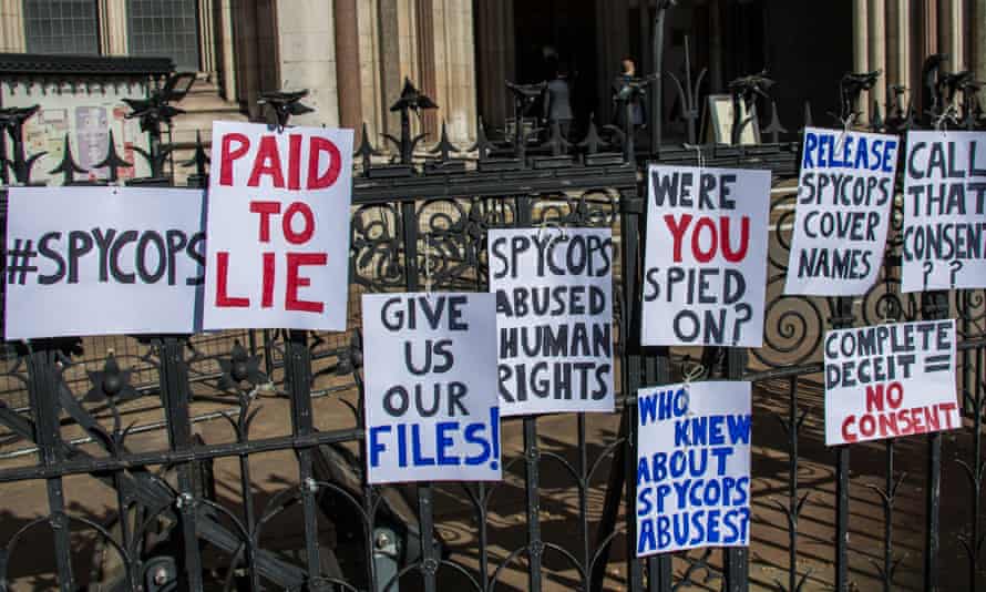 Signs by protesters at the Royal Courts of Justice in 2019.
