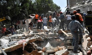 People remove debris from a collapsed building in Mexico City.