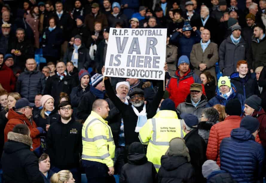 A fan holds a boycott VAR sign in the stands at the Etihad.