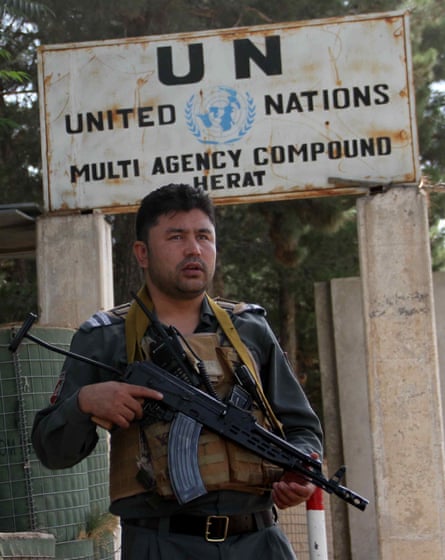 An Afghan security official standing guard outside the UN office in Herat