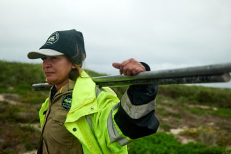 A ranger carries a post