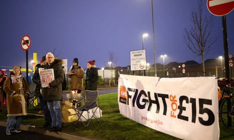 Members of the GMB union stand on the picket line as they hold a strike outside the Amazon warehouse in Coventry, Britain, January 25, 2023.