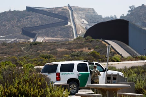 a border patrol vehicle is parked near a border wall