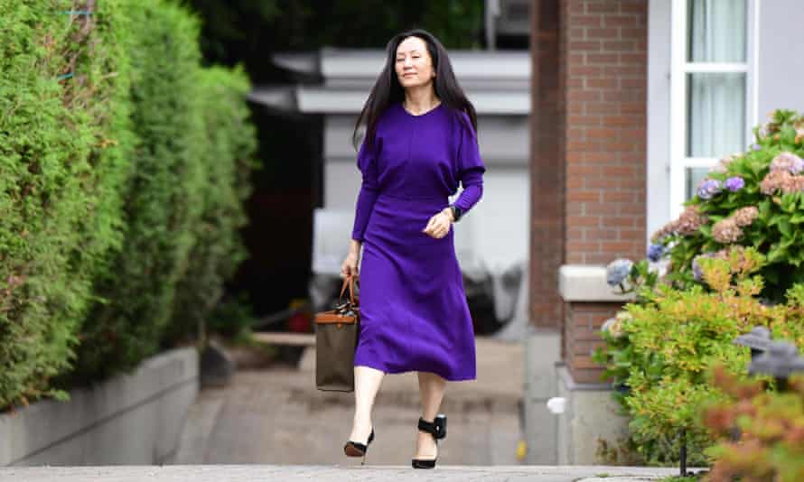 Meng is seen leaving her home with a tracking device strapped to her ankle in Vancouver on 18 August.