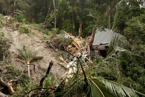A house sits destroyed at the bottom of a landslide