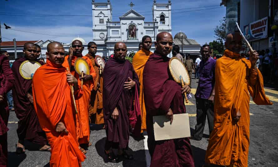 Buddhist monks outside St Anthony’s Shrine in Colombo, a day after the church was hit in series of bomb blasts.