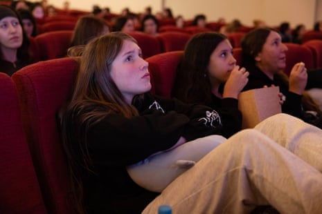 Sienna Johnson and Hadley Ventura, both 12, settle in to watch