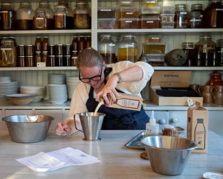 A chef pours milk into a measuring jug at Järvsö Lanthandel country shop