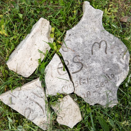 Smashed memorial stones in the grass