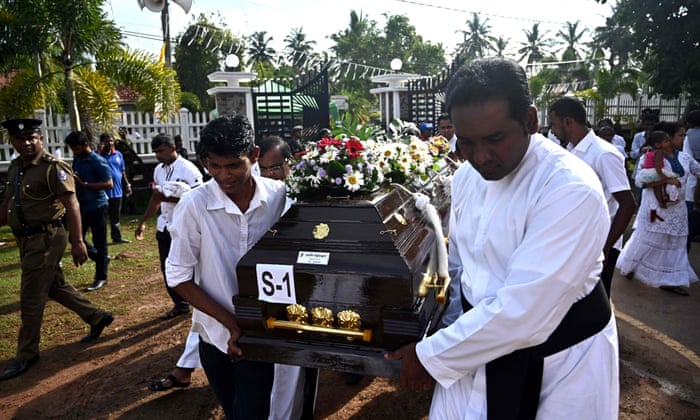Priests and relatives carry the coffin of a bomb blast victim after a funeral service at St Sebastian’s Church in Negombo.