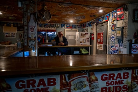 A man standing behind a bar