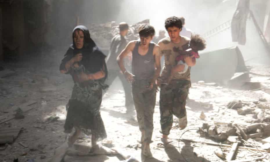 A fleeing woman and youths, one of them carrying a baby, Aleppo, 2014