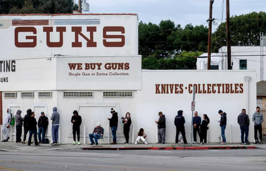People wait in a line to enter a gun store in Culver City, California.
