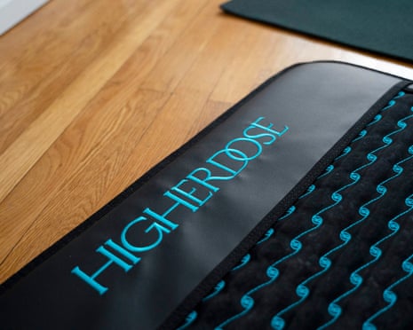 blue and black mat that says 'higherdose' on wood floor