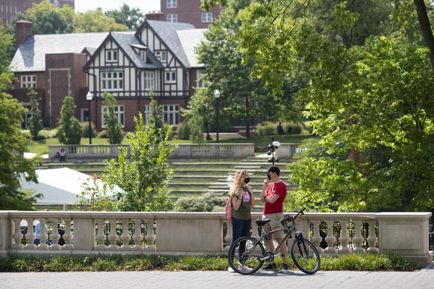 Students wearing protective masks talk on campus on the first day of classes at Ohio State University in Columbus, on 25 August.