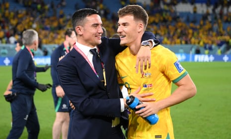 Tim Cahill, Australia’s head of delegation in Qatar, congratulates midfielder Ajdin Hrustic after the 1-0 victory over Denmark.