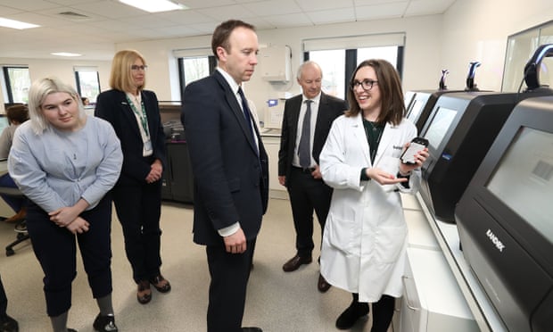 The health secretary, Matt Hancock, is shown a demonstration of a blood testing machine in operation during a visit to Randox in County Antrim