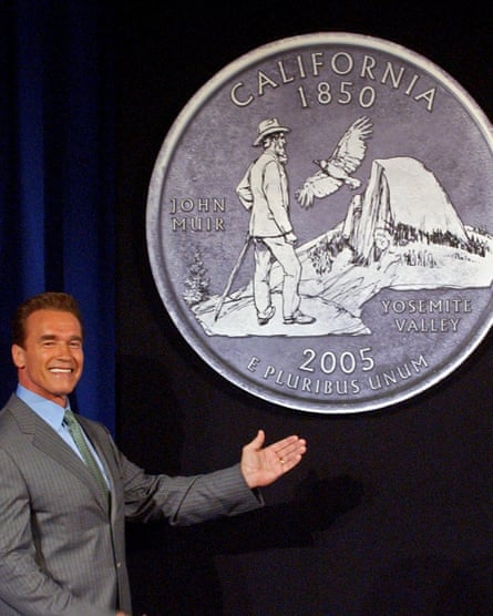 Then-California Governor Arnold Schwarzenegger displays the final choice for the California commemorative quarter, featuring an image of naturalist John Muir.