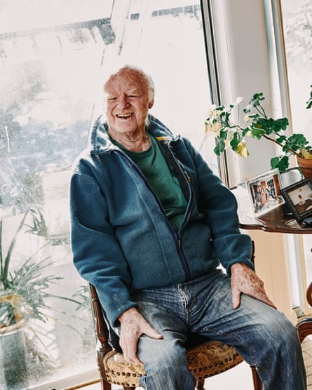 A man sits next to a window
