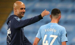 Phil Foden, who scored one and set up another goal for Raheem Sterling, is congratulated by his manager Pep Guardiola.
