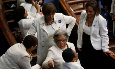 Democratic members of the House of Representatives talk before Trump’s address. Many women wore white in protest – a nod to the suffragette movement. 