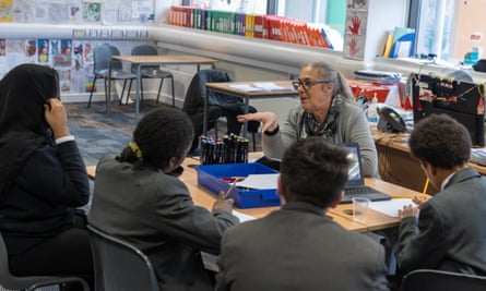 Amanda O’Connor in a classroom with four pupils with their backs to the camera.