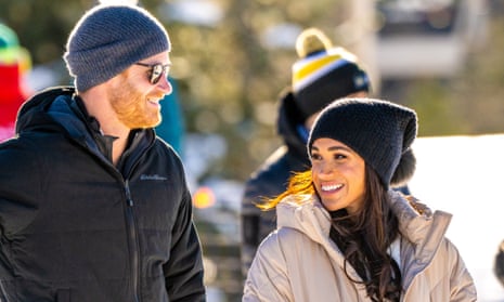 The Duke and Duchess of Sussex wearing woolly hats and smiling in Whistler, Canada.