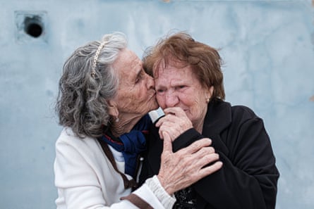 Silvestra, right, and a friend embrace