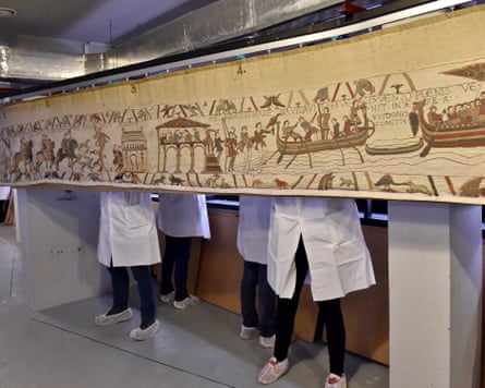 Workers moving the tapestry in the Bayeux Museum.