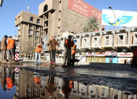 Cleaners sweep the site of a deadly Thursday evening’s bombing in Baghdad’s central district of Karrada in Baghdad, 7 March 2008