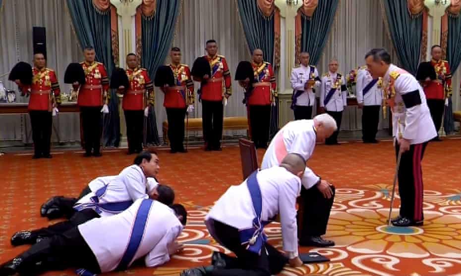 Thai prime minister Prayuth Chan-Ocha (centre), privy council president General Prem Tinsulanonda (seated) and others prostrate themselves in front of newly appointed Thai King Maha Vajiralongkorn.
