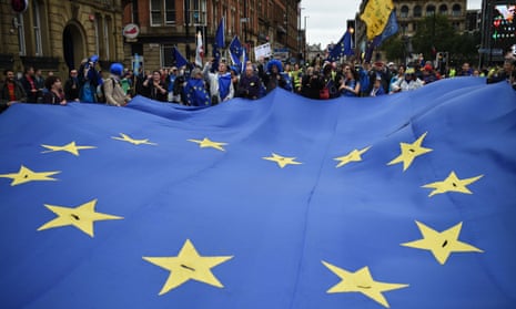 Protesters carry an EU flag